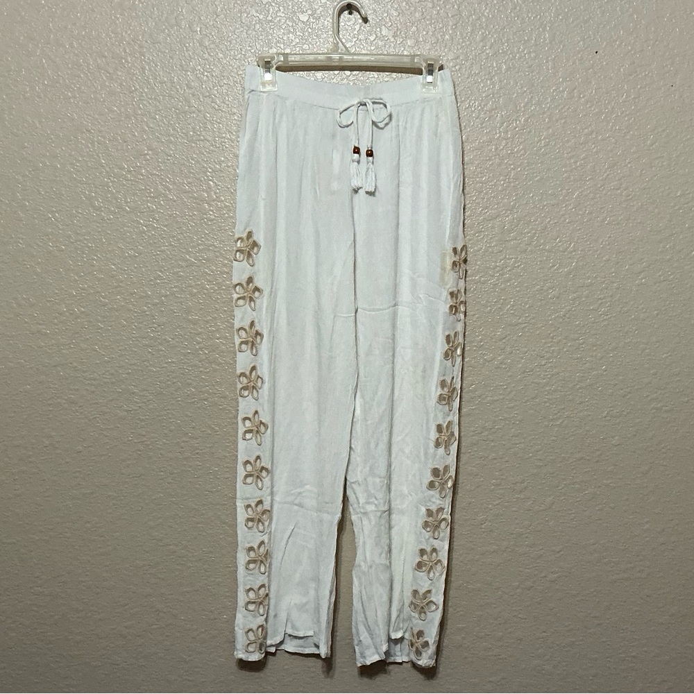 White Drawstring Pants with Tan Cutout Floral-Trim. Perfect for the Beach.